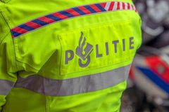 Close-up of a Dutch police officer's high-visibility jacket