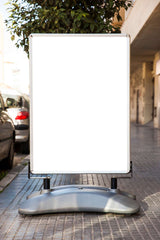 Blank outdoor advertising board on city sidewalk