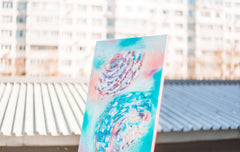 Colorful abstract painting against urban backdrop