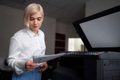 Woman using printer in office setting