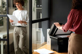 Professional women working, reading and using photocopier