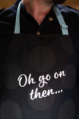 Close-up of apron with text 'Oh go on then...'