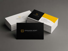 Stack of custom-designed business cards in black and yellow