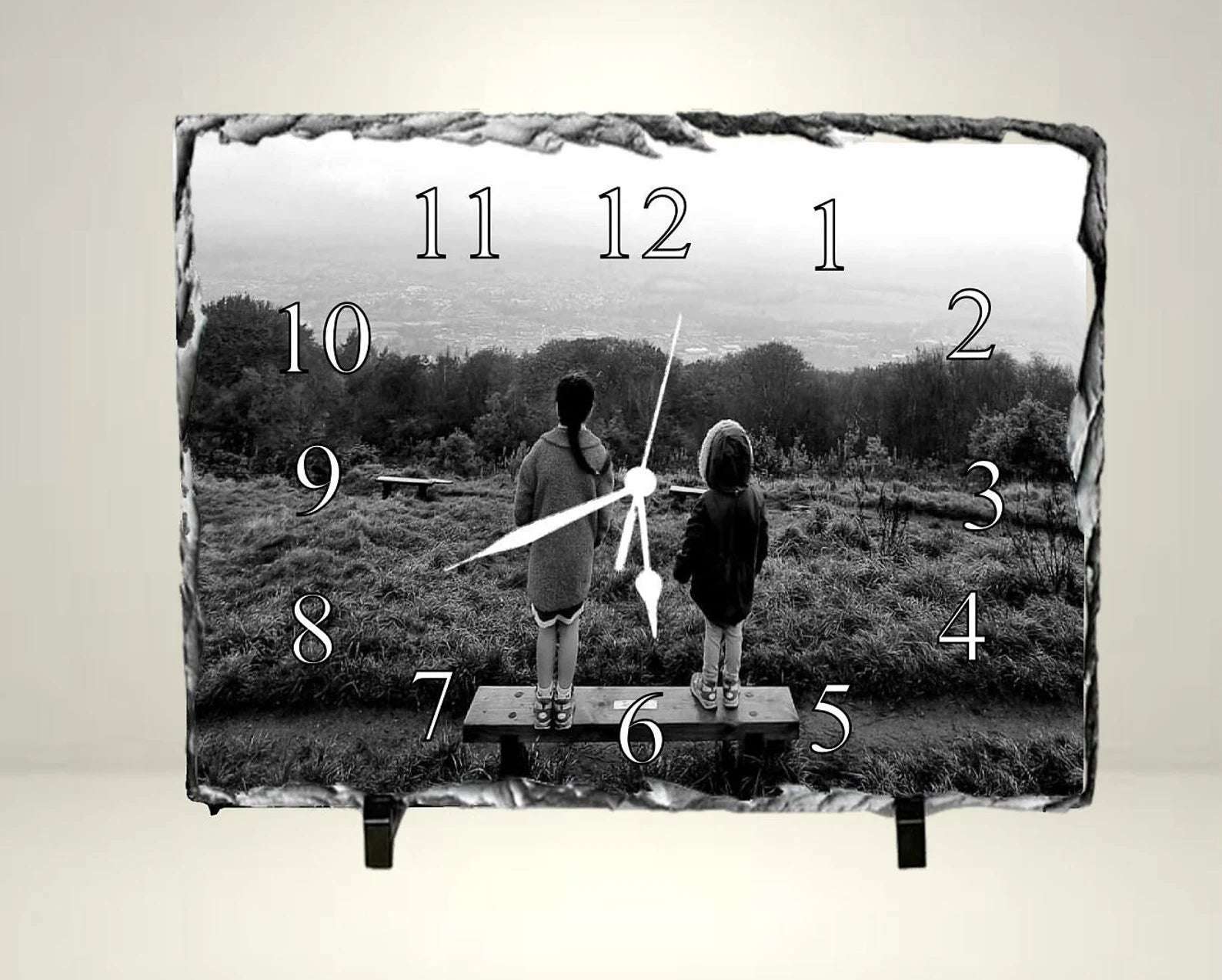 Surreal image of children inside clock overlaying landscape